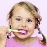 Young girl brushing her teeth